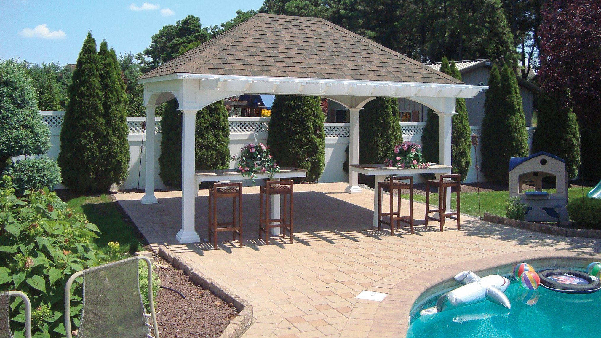 Manor vinyl pavilion with bar seating near pool.