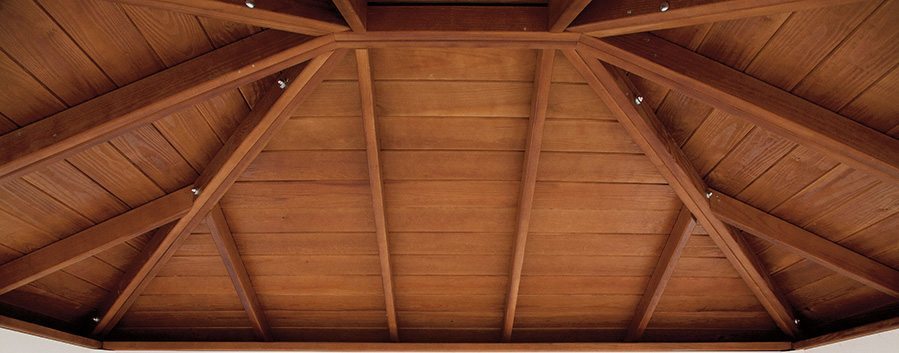 Underside view of a stained wood roof ceiling.