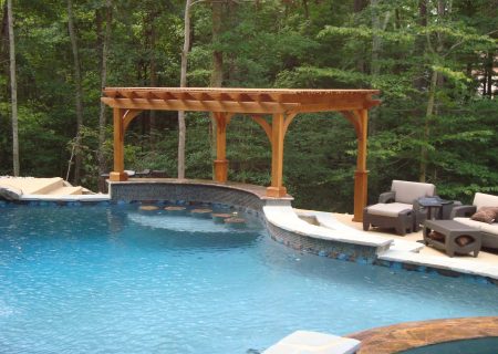 Wood pergola over backyard pool bar.