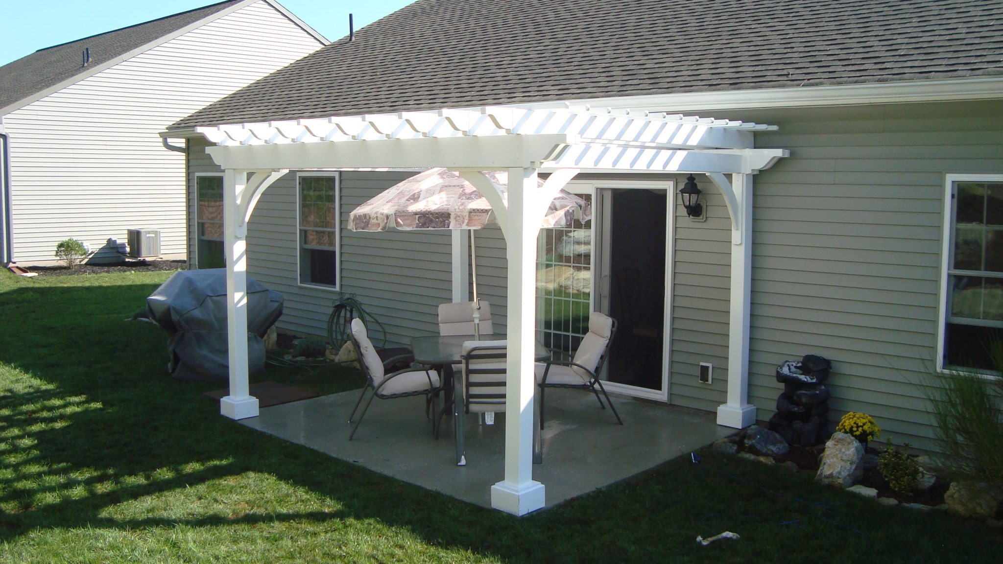 Small vinyl pergola over patio dining set.