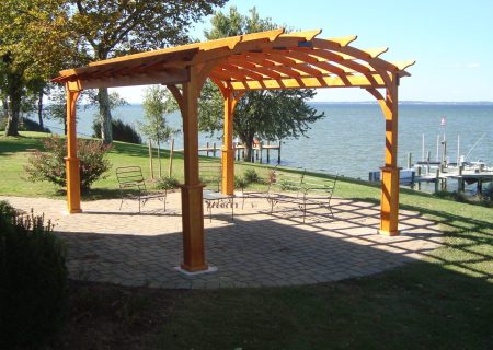 Cozy arch pergola on waterfront.